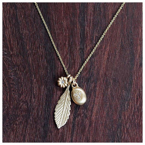 Our Three's a Charm necklace features our Medium Leaf pendant, Blossom Diamond flower and Victoria Pendant that hang together from a 16" 14K gold chain.