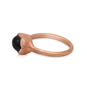 Side view Our Willa ring in 14K rose gold shown with black sapphire