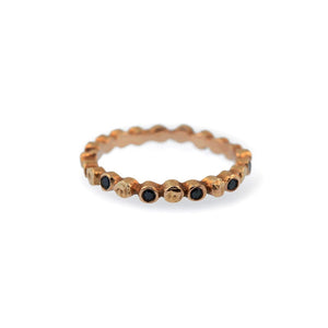 Dot ring in 14K rose gold  It has a black diamond in every other unique textured dot.