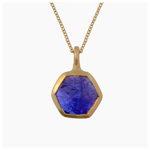 Our Hexagon pendant shown in 14K yellow gold with blue sapphire