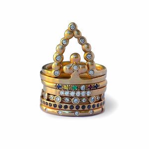 Our Beatrix ring shown in 14 yellow gold and 7 round white diamonds shown stacked with other rings