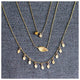 This leaf necklace features a horizontal hanging leaf shown in 14K yellow gold shown with other necklaces sold separately.
