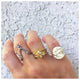 ancient horse ring in 14K yellow gold shown worn on hand with other rings