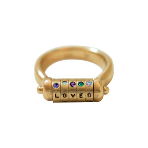 Our Disc Swivel Ring features 5 Discs that spell out a name or word with one handstamped letter and 5 corresponding stones. Shown is loved