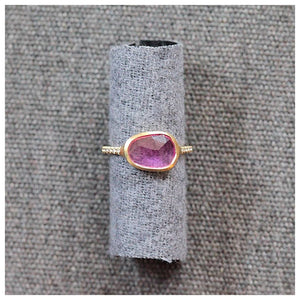 This handcrafted ring features a gorgeous Rosecut Sapphire with 5 pave diamonds on either side