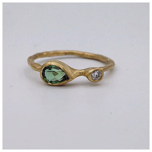 Sonja Green Tourmaline and Diamond Ring shown in 14K Yellow gold on gray background.