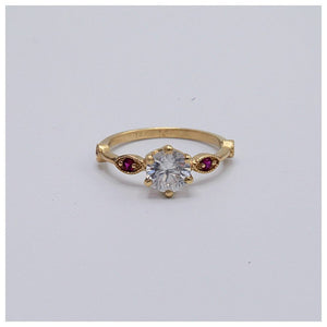 Arielle ring in 14K Yellow gold shown with white sapphire center stone and ruby side stones.
