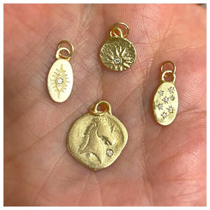 Sunburst pendant in 14K yellow with white round diamond shown with other charms