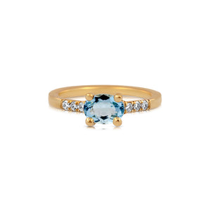 14K yellow gold stella ring with oval aquamarine center stone and 3 pave set diamonds on either side
