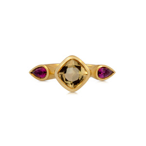 Eve Ring shown in 14 yellow gold This handcrafted features a beautiful golden Morganite center stone with 2 dark pink tear shaped Tourmalines on either side