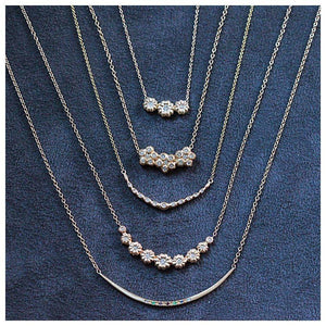 Our blossom three diamond necklace  shown in 14K yellow gold with white diamond shown with other pieces all sold separately