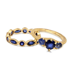 Sapphire Eternity Ring with 6 marquis and 6 round blue sapphires all around in 14K yellow gold shown with our Essie ring