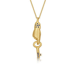 Our hand and key pendant in 14K gold with blue sapphires