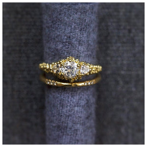 Jocelyn White Sapphire Ring with Textured Diamond band on ring roll.