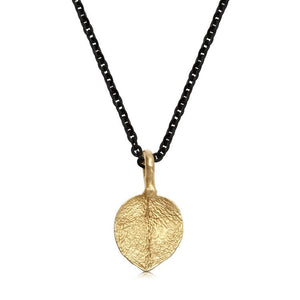 This delicate leaf necklace is shown with a 14K gold pendant on a 16" Sterling Silver Rhodium Plated chain.