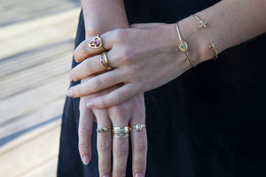 Eleanor ring in 14 K yellow gold with pear shaped Ruby center stone on hand