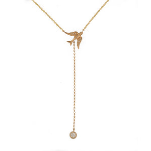 Bird pendant is shown in 14K yellow gold with two 1mm diamonds in each wing. It hangs from a 16" 1mm 14K yellow gold chain with a 3mm diamond hanging from a 2” lariat