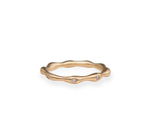 Our Seaweed ring in 14K yellow gold with 9 round white diamonds set all around the band