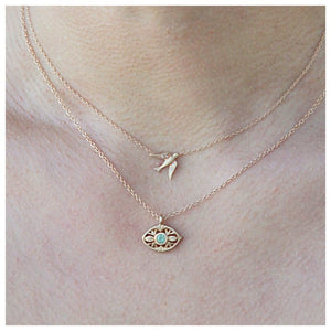 Luna eye pendant in 14K yellow gold with tourmaline center stone show on neck