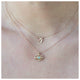 Luna eye pendant in 14K yellow gold with tourmaline center stone show on neck