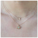 Our bird necklace with 4 white round diamonds in 14k yellow gold