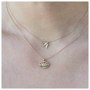 Luna eye pendant in 14K yellow gold with tourmaline shown on neck with other necklace sold separately