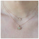 Luna eye pendant in 14K yellow gold with tourmaline shown on neck with other necklace sold separately