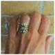 Blossom ring in 14K yellow gold with white diamond on hand with other rings sold separately
