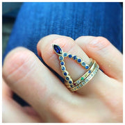 Beatrix marquis ring in 14K yellow gold with blue sapphires on finger with other rings sold separately