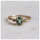 Our Candy ring with a green tourmaline center stone, 2 champagne diamond side stones shown in 14K Yellow gold.