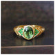Our Carla Ring features a gorgeous Tourmaline green center stone surrounded by emeralds on either side