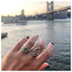 Carla Ring Tourmaline center stone and Emeralds in 14K Yellow gold. shown on finger