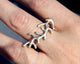 Coral Long Ring Shown in Sterling Silver. This handcrafted coral inspired ring measures 1 1/4 of an inch across.It sits comfortably on the finger peeking a bit over the 2 fingers it is next to, and can even be stacked with other rings.Adored by all cultures, coral symbolizes rebirth, wealth, and protection.Shown in Sterling Silver.