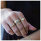 Double bud ring in 14K yellow gold with gray and white diamond worn with other rings sold separately
