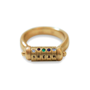 Disc Swivel Ring, each disc has either letters or stones to spell a name or word. Shown in 14K Yellow gold with multi colored stones.