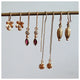 Hand carved bead earrings in 14K yellow gold shown with other earrings