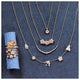 Our garden necklace shown in 14K gold with our blossom flower, bird, leaf, and laura flower shown with other necklaces