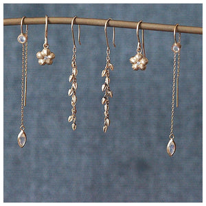 Hanging Gisselle earrings in 14K yellow gold shown with other earrings