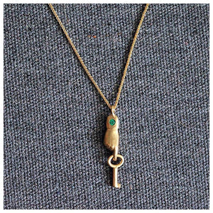 This sweet Hand pendant is shown with a 2.5mm Emerald holding a key in 14K yellow gold