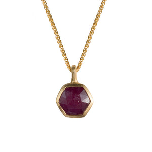 Our hexagon pendant in 14K yellow gold with ruby stone