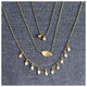 This leaf necklace features a horizontal hanging leaf shown in 14K yellow gold shown with other necklaces sold separately.
