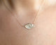 This leaf necklace features a horizontal hanging leaf shown in 14K yellow gold shown on neck.