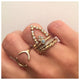Ines ring with round opal center stone and 3 diamonds on top in 14K yellow gold shown stacked on hand