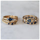 Janie ring in 14K yellow gold with 3 round blue sapphires shown with other blue sapphire rings