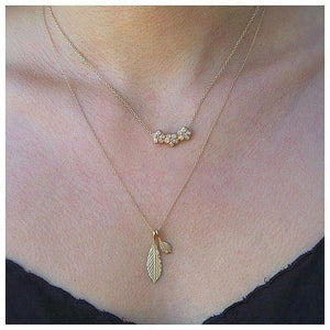 Laura Diamond Pendant on neck This beautiful flower pendant features 3 flowers together that each feature 6 brilliant diamonds (.21 TCW) in each flower and hangs from an 16" gold chain