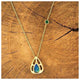 Maria pendant features a beautiful pear shaped dark blue and green opal center stone set in a rich 14K yellow gold. and round emerald stone on the chain.