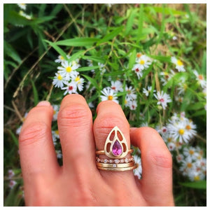 Our Maria ring is a stunning statement piece with a beautiful ruby pear shaped center stone set in a rich 14K yellow gold with other rings sold separately