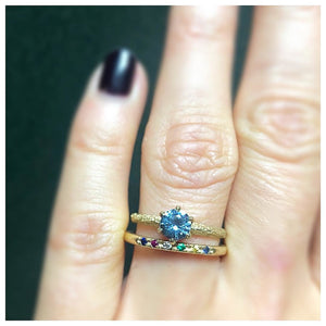 Marie Ring with Montana Sapphire center stone shown in 14K Yellow gold. Shown on finger stacked with our Message Me ring.