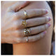 Blossom 3 Flower Ring with White Diamond and other rings on hand
