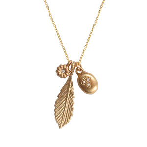 Our Three's a Charm necklace features our Medium Leaf pendant, Blossom Diamond flower and Victoria Pendant that hang together from a 16" 14K gold chain.